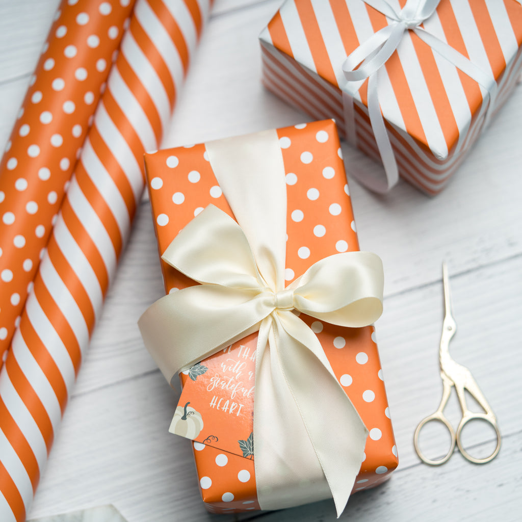 Different Colorful Wrapping Paper Rolls Scissors And Ribbons On